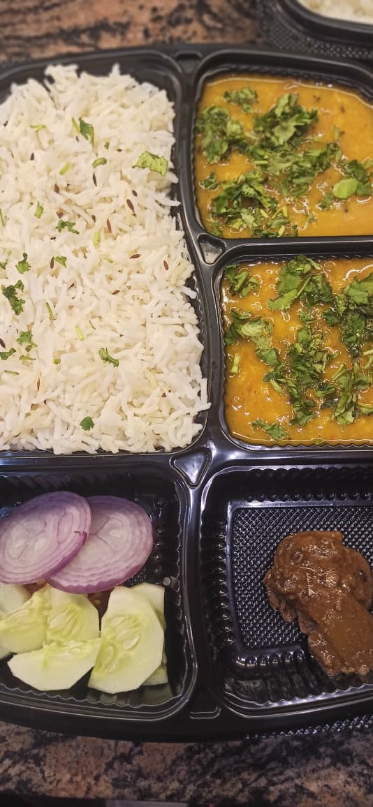 Dal tadka with jeera rice, onion & pickle thali — vegetarian office lunch in Noida